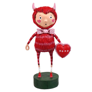 Red devil love monster figurine with pink horns and polka dot bow tie holding heart cushion spreading holiday cheer folk art