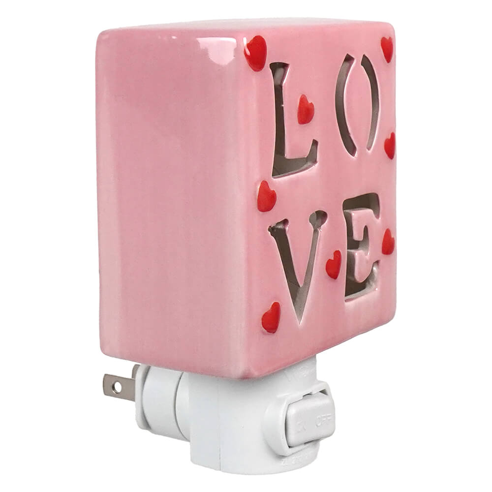 Pink ceramic valentine’s day night light with love cutout and red heart accents for cozy decor