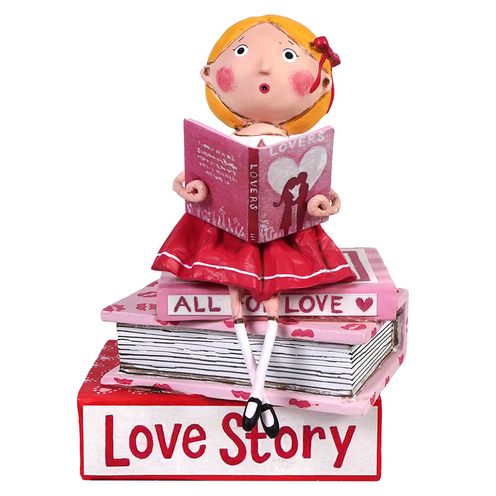 A decorative figurine reading love-themed books while sitting atop a stack of romantic novels.