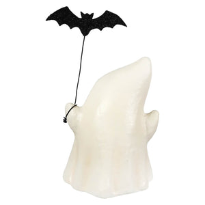 A white ghost luminary figurine holding a black glitter bat on a string boo with bat decoration
