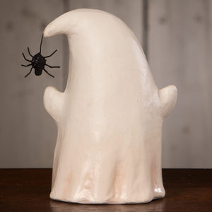 A smooth off-white ceramic luminary boo with spider featuring a glossy finish and black plastic spider for halloween decor