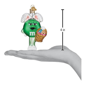 Green m&m’s easter ornament wearing white bunny ears and holding a woven basket perfect for food & drink ornaments