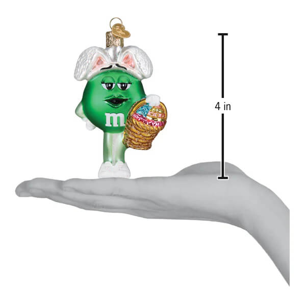 Green m&m’s easter ornament wearing white bunny ears and holding a woven basket perfect for food & drink ornaments