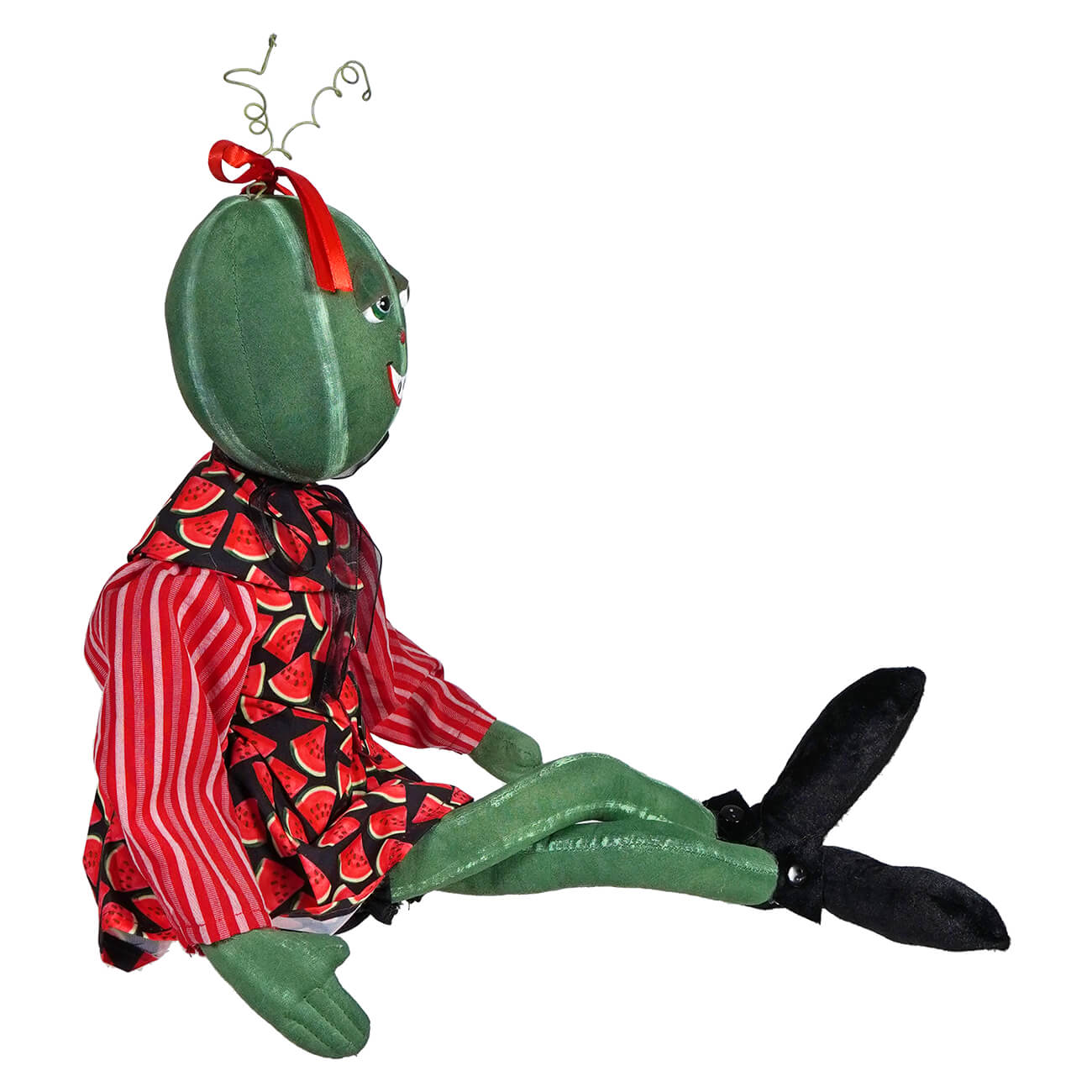 Whimsical plush frog doll wearing red striped and patterned clothing.