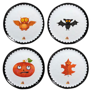 Four circular plates with Halloween-themed designs featuring an owl, bat, pumpkin, and autumn leaf.
