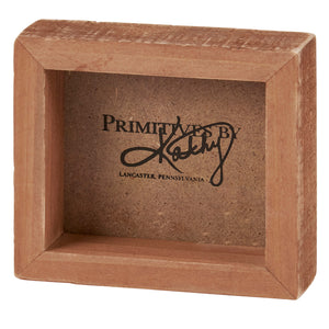 Simple brown wooden display box with ’Primitives by’ branding from Lancaster, Pennsylvania.