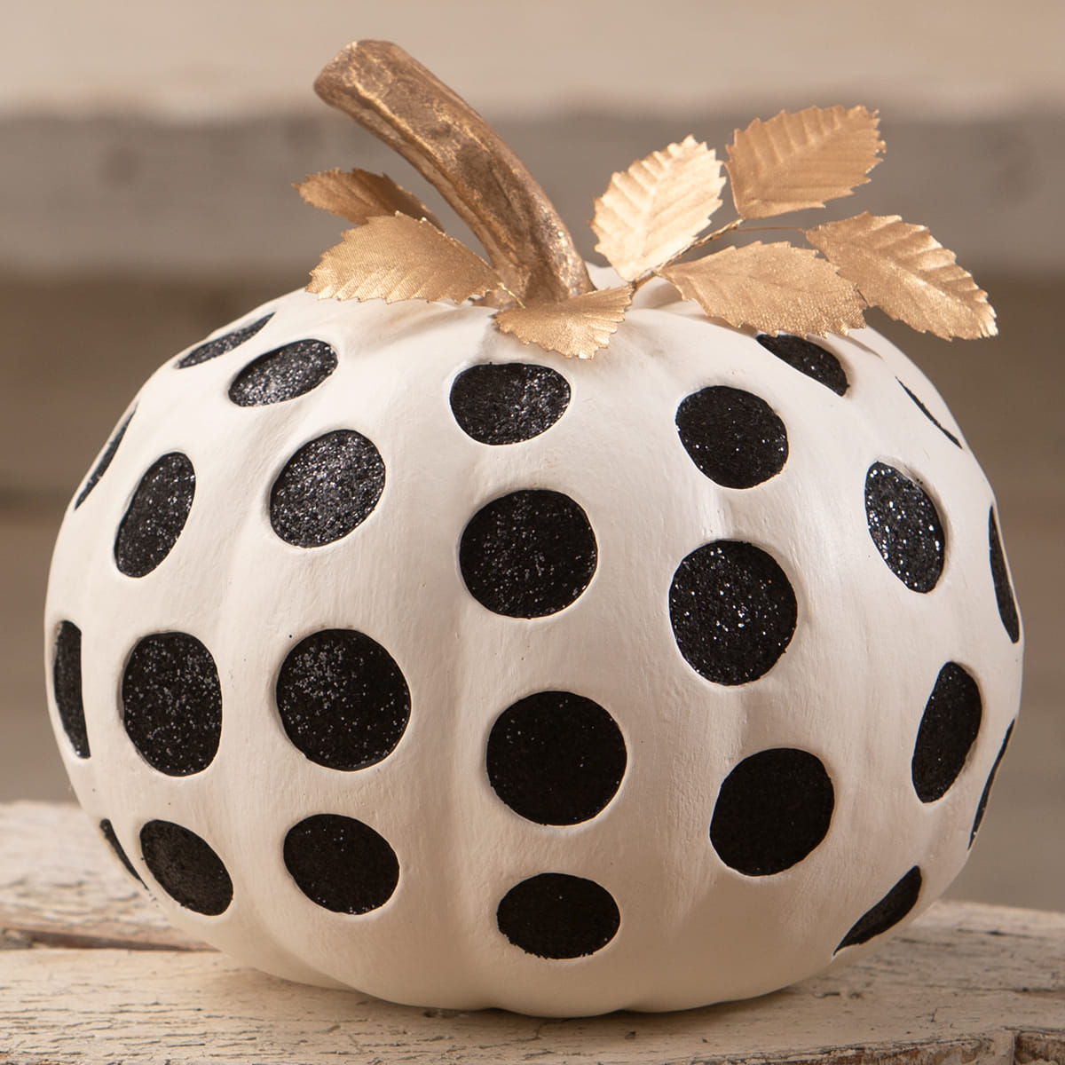 Medium dottie blanc pumpkin with white base black glitter polka dots and a gold leaf stem perfect for halloween pumpkins and gourds