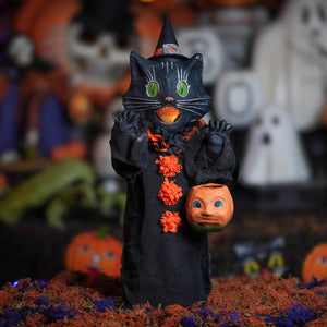 Medium scaredy cat black witch cat figurine with green eyes orange pumpkin face and black robe with orange floral accents