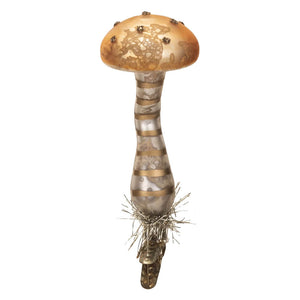 Glass Christmas tree ornament shaped like a mushroom with a golden cap and striped stem.