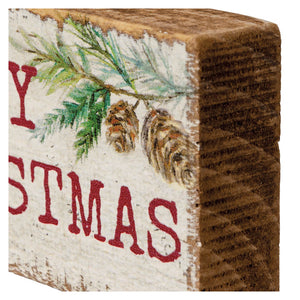 Wooden block with ’STMAS’ text and pine branch decoration, likely part of a ’CHRISTMAS’ sign.