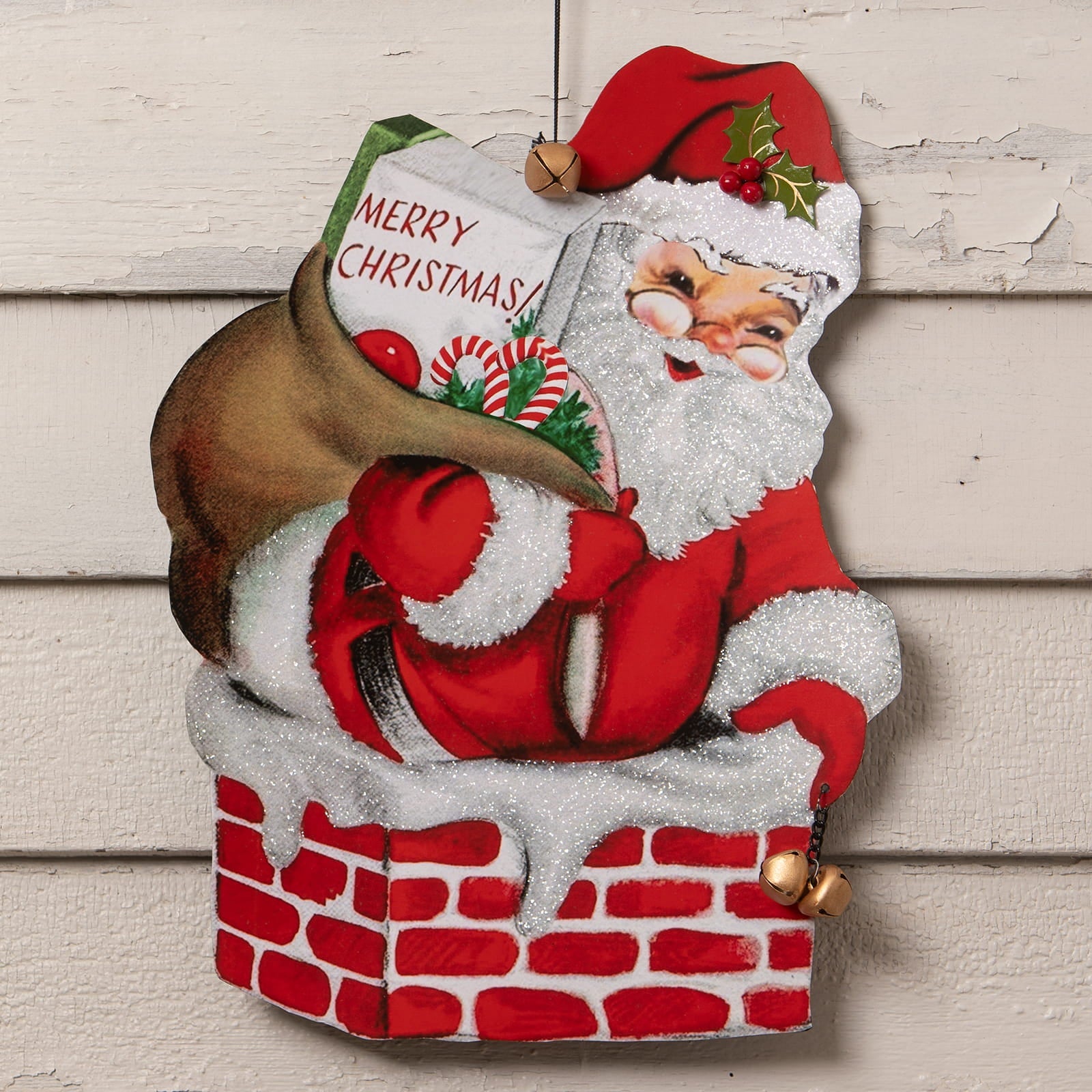 Red and white glittery bethany lowe christmas santa sign hanging from a chimney holding merry christmas book