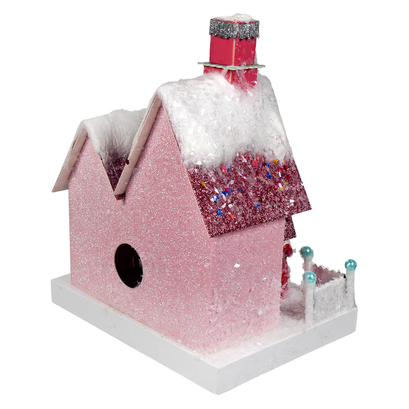 A pink glitter christmas house with a snowy roof and red sparkly chimney from cody foster merry holiday house
