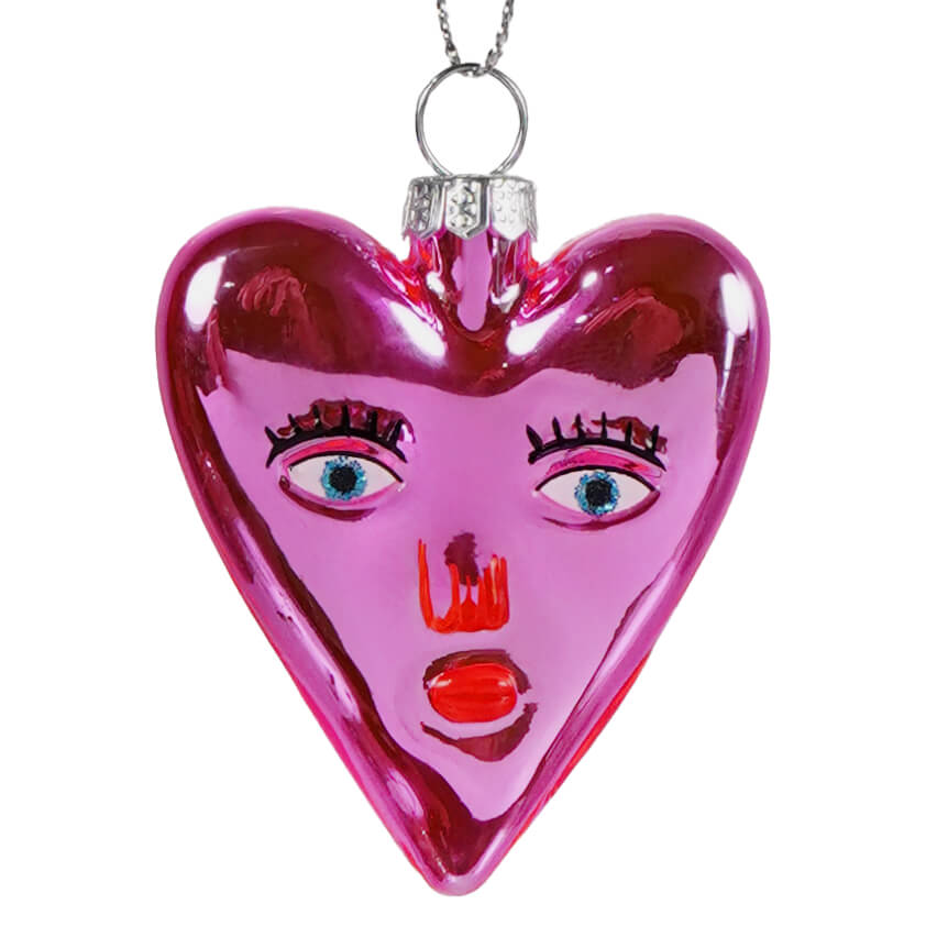 Mi amor heart glass ornament is a glossy pink heart ornament with a stylized face, perfect as a valentine’s day ornament