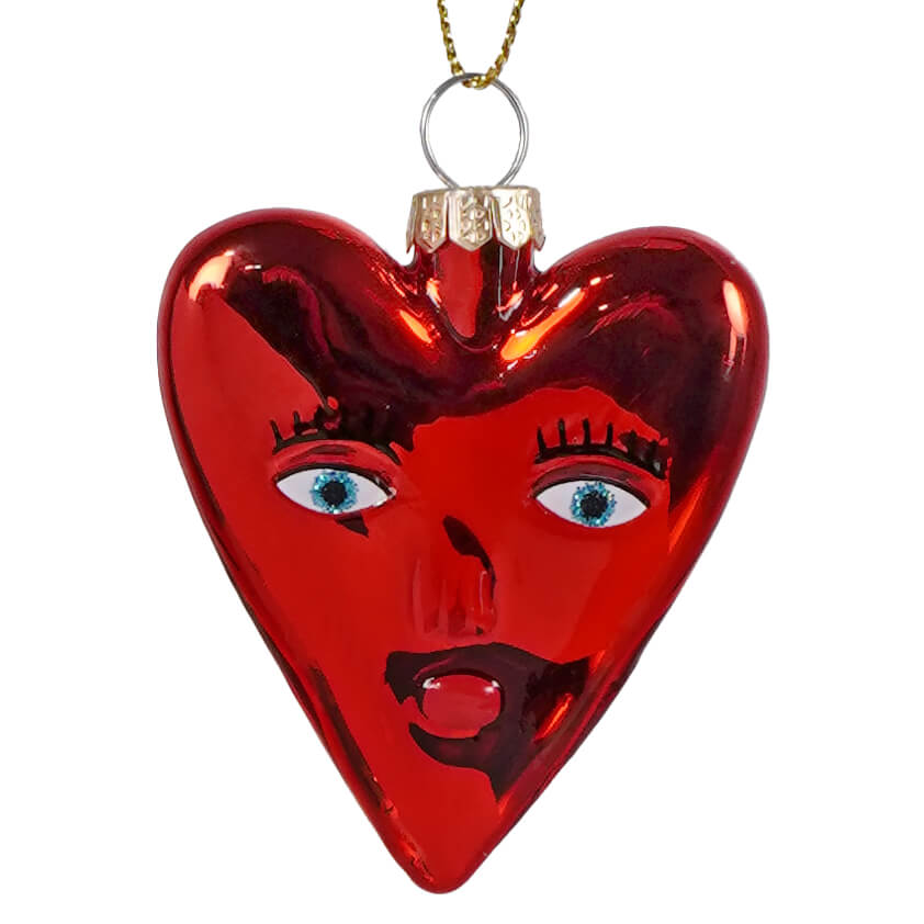 Mi amor heart glass ornament is a glossy red heart ornament with painted blue eyes black lashes and a dark mouth perfect for cody foster fans