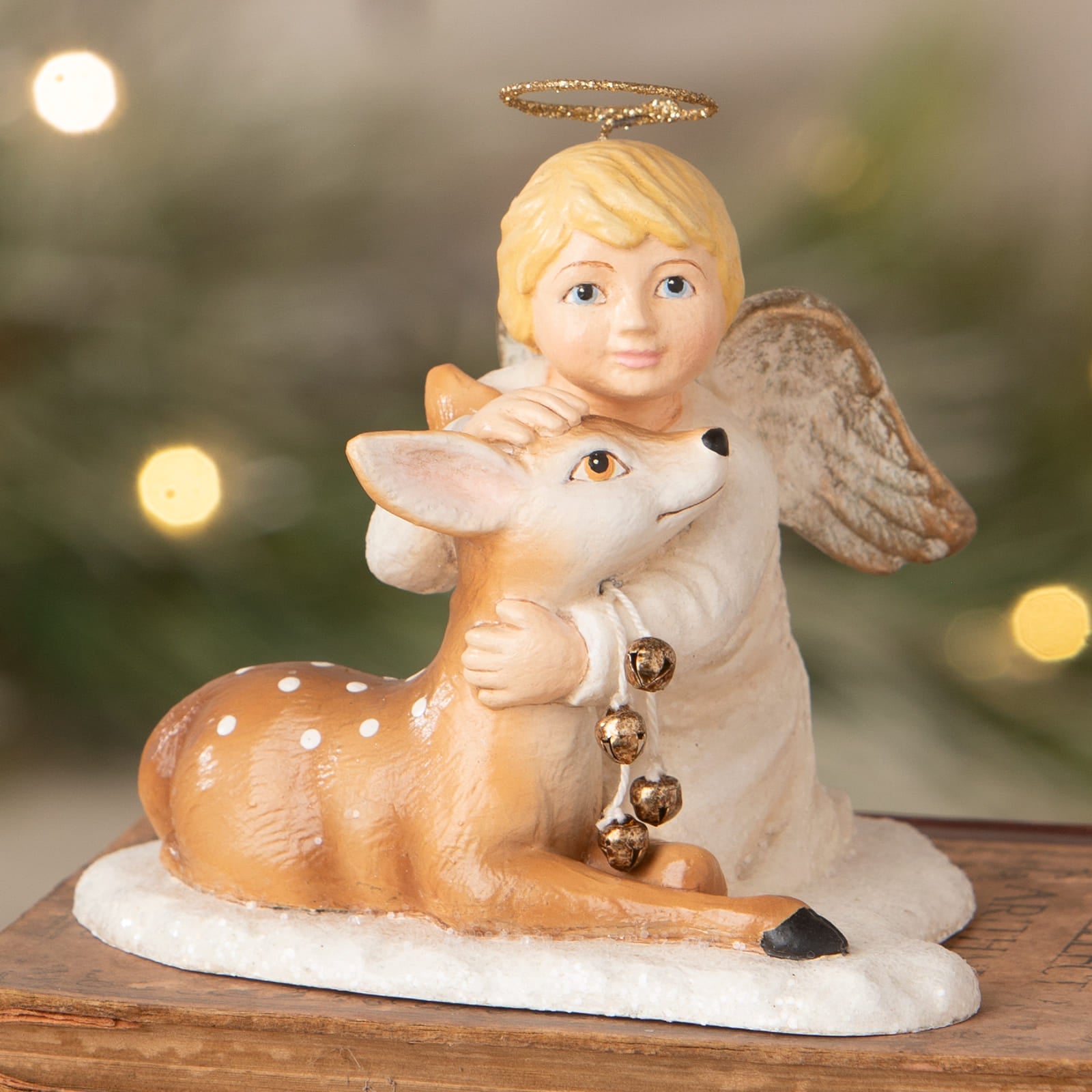 Michael angel porcelain figurine with blonde hair embracing spotted fawn with golden bells bethany lowe decor