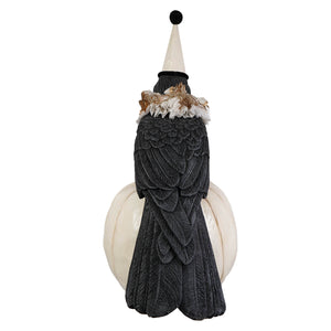 A black detailed messenger crow figurine wearing a white jester hat with gold trim by bethany lowe halloween