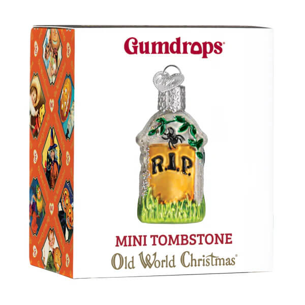 Mini tombstone ornament made of clear glass with a yellow plaque green grass base and black r.i.p. lettering
