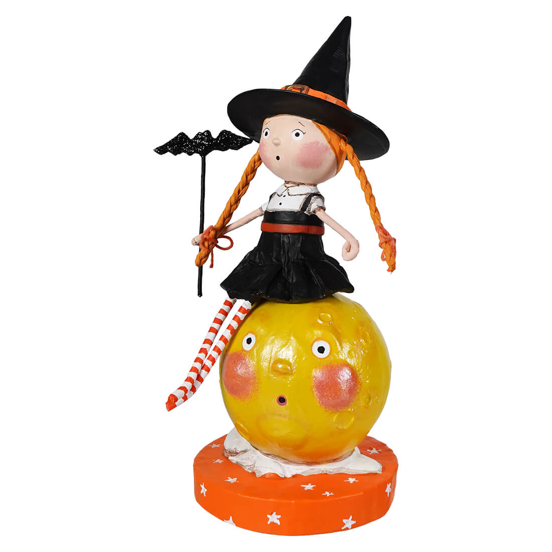A lori mitchell halloween whimsical witch figurine with orange braided hair on a yellow pumpkin base from mischief on the moon