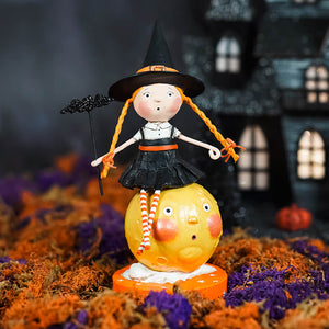 A lori mitchell halloween witch figurine with orange braided hair on a yellow moon base called mischief on the moon