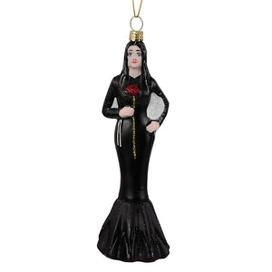 Black glass morticia addams glass ornament by cody foster showing woman in glossy black gown holding red rose