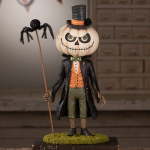 A whimsical halloween figural decor of mr gourdy pumpkin-headed gentleman with top hat and spider stick