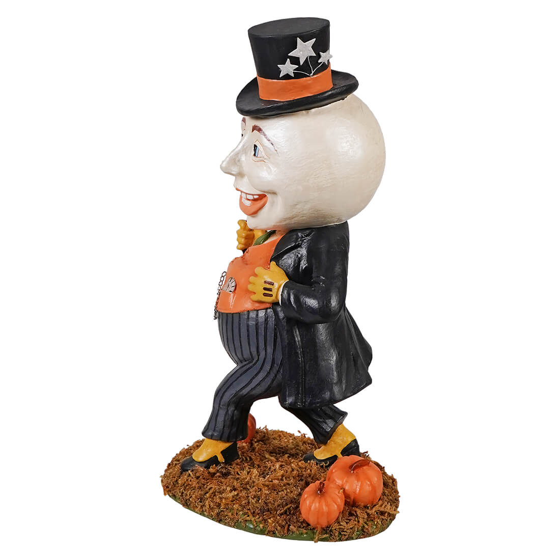 A halloween-themed figurine of harvey moon man wearing a black starry top hat and holding an orange pumpkin bag