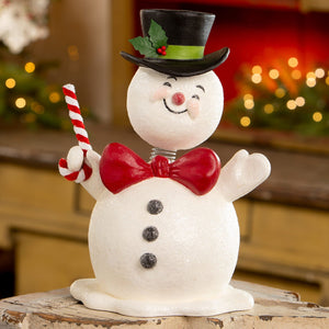 A cheerful white glittery snowman figurine with top hat and candy cane bethany lowe design jolly bobble head christmas decor