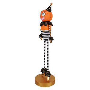 Orange pumpkin man tabletop figurine dressed in black and white stripes with gold accents and a festive hat halloween kook
