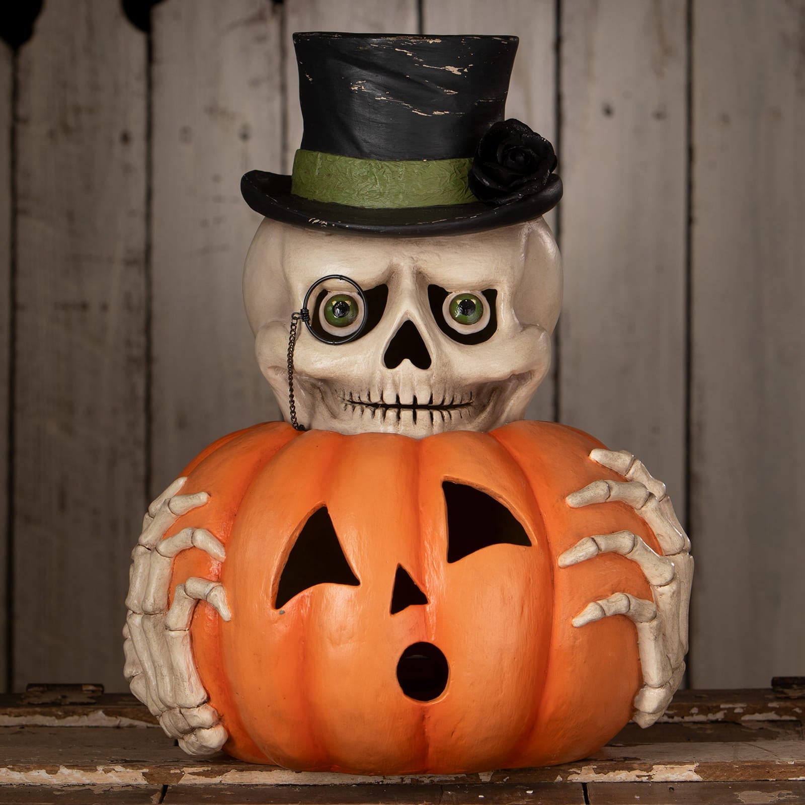 Mr skully skeleton decor figure in white with black top hat holding halloween pumpkins orange jack o lantern