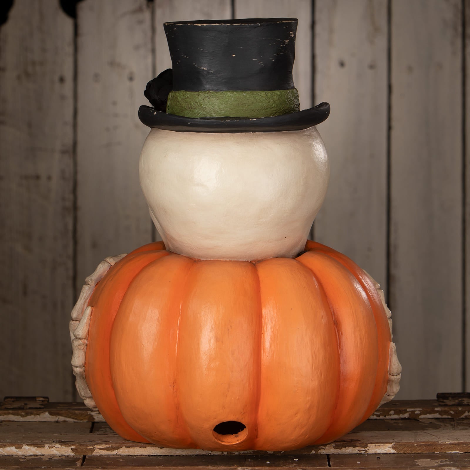 Mr skully halloween pumpkins planter shaped like a snowman with orange pumpkin base white skeletal hands and black top hat