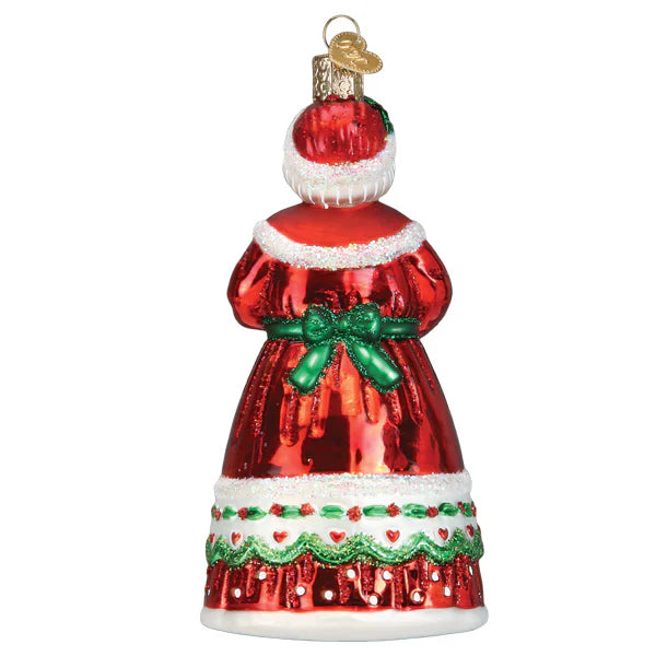Red glass mrs claus ornament shaped like santa with white fur trim green bow and decorative lace details