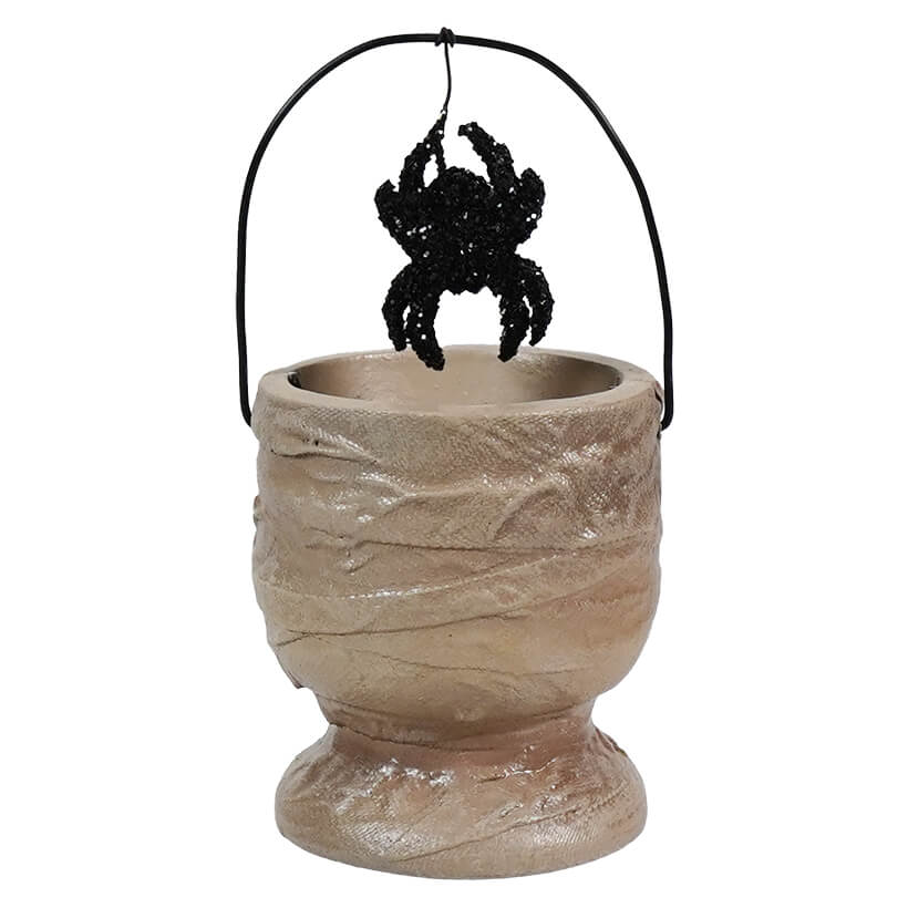 Halloween-themed candy bucket designed to look like a mummy’s wrappings with a hanging spider decoration.