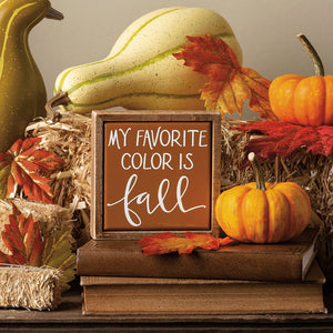 A rustic wooden fall farm wagon block sign with a warm brown background and white cursive lettering my favorite color is fall