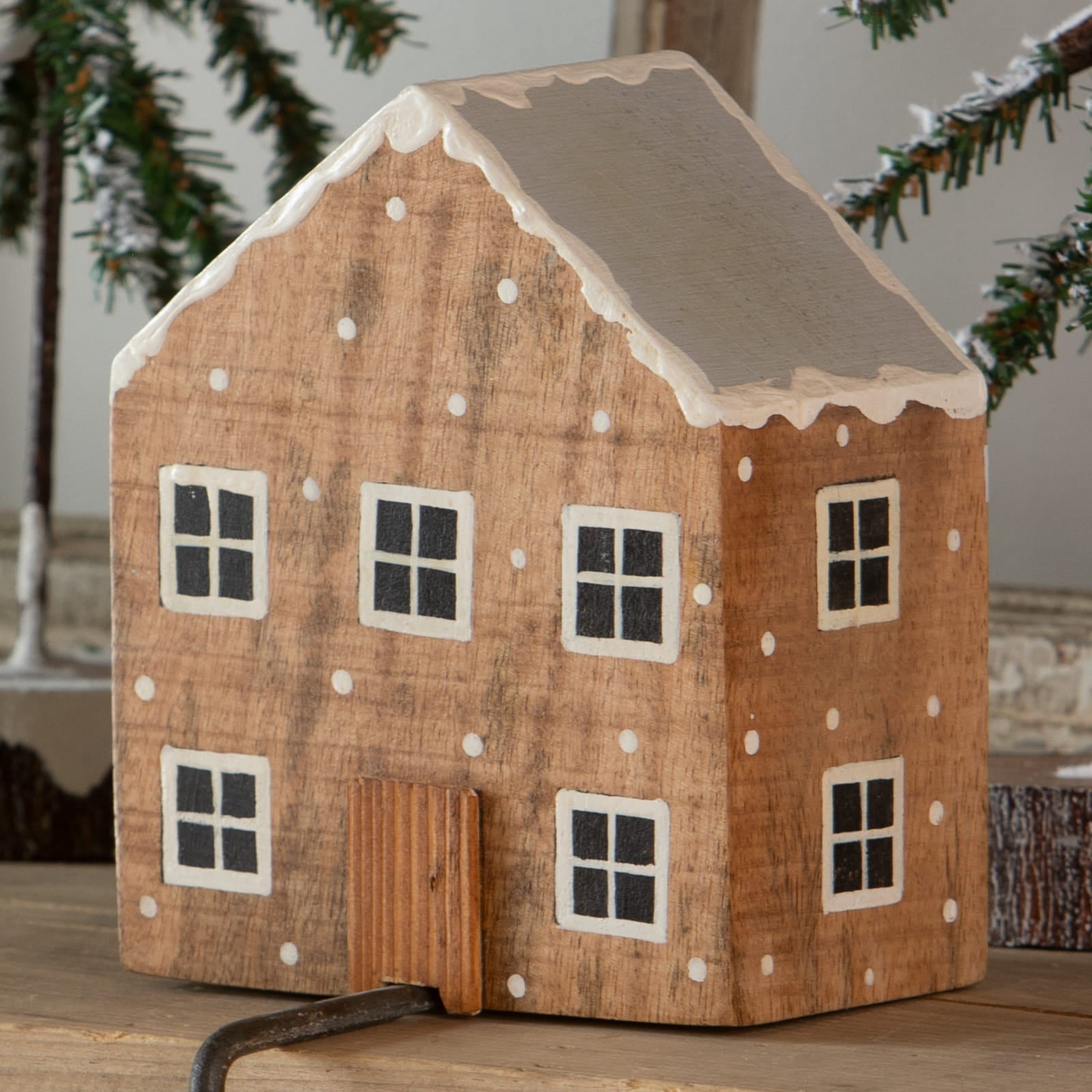 Rustic wooden natural house stocking holder with gray roof white icing trim and snowflake dots for christmas stockings