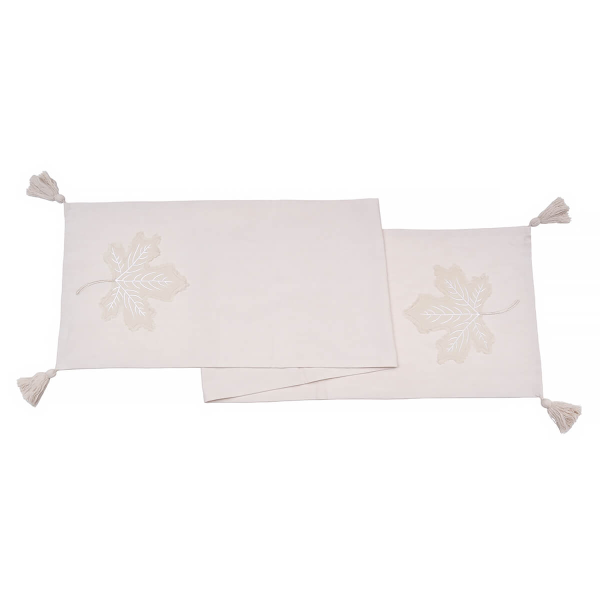 Two off-white rectangular placemats with tassels at the corners.