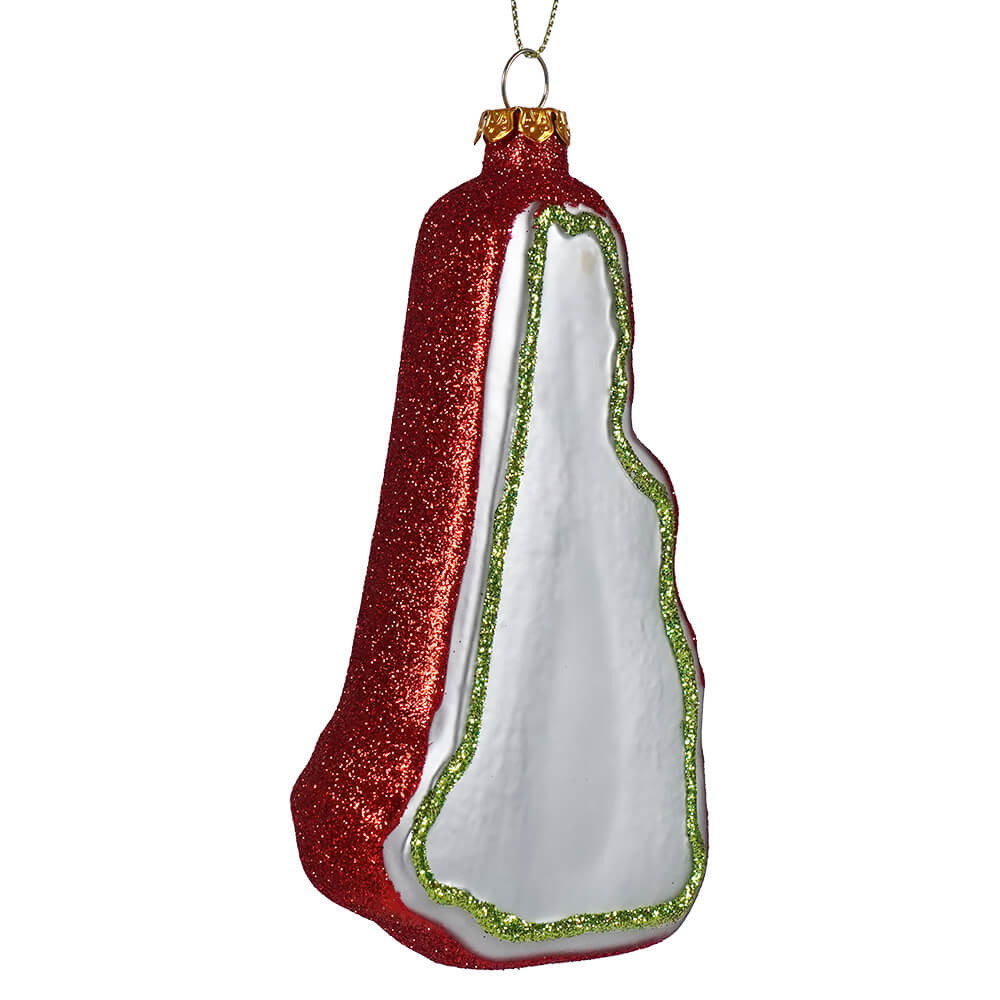 A red and white glittery glass hampshire state ornament shaped like a cape with green glitter trim perfect for fall foliage road trip decor