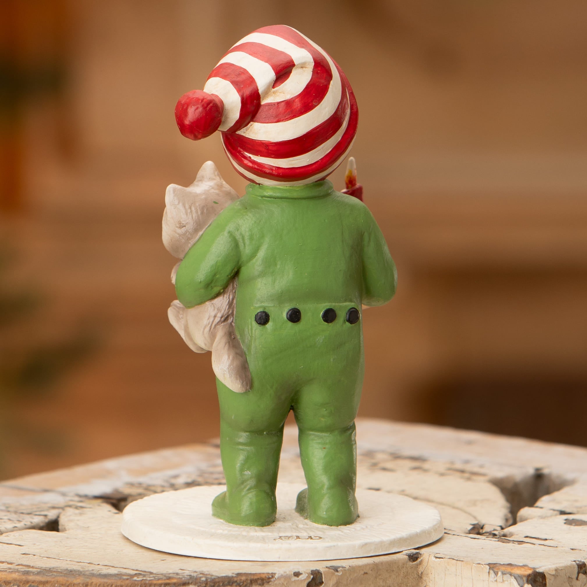 A charming bethany lowe christmas elf ornament in green holding a small cat perfect for holiday decorations