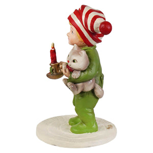 A bethany lowe elf figurine in green with a red and white hat holding a cat and a candle for christmas decorations