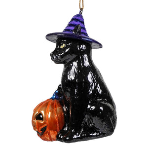 Glossy black glass halloween cat ornament with purple striped hat sitting by orange pumpkin from kurt adler noble gems