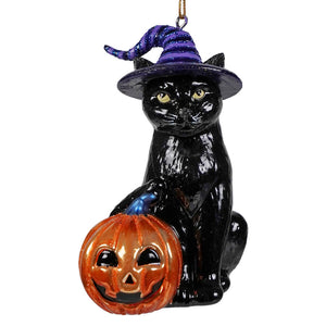 Glossy black glass halloween cat ornament with yellow eyes and purple hat beside orange jack o lantern by kurt adler noble gems