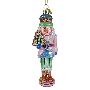 A glass nutcracker ornament from kurt adler noble gems™ collection with teal crown, pink coat, and candy decorations