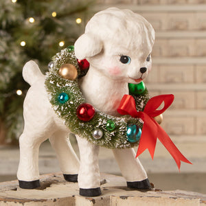White ceramic noelle lamb figurine by bethany lowe design with festive wreath and bright red bow