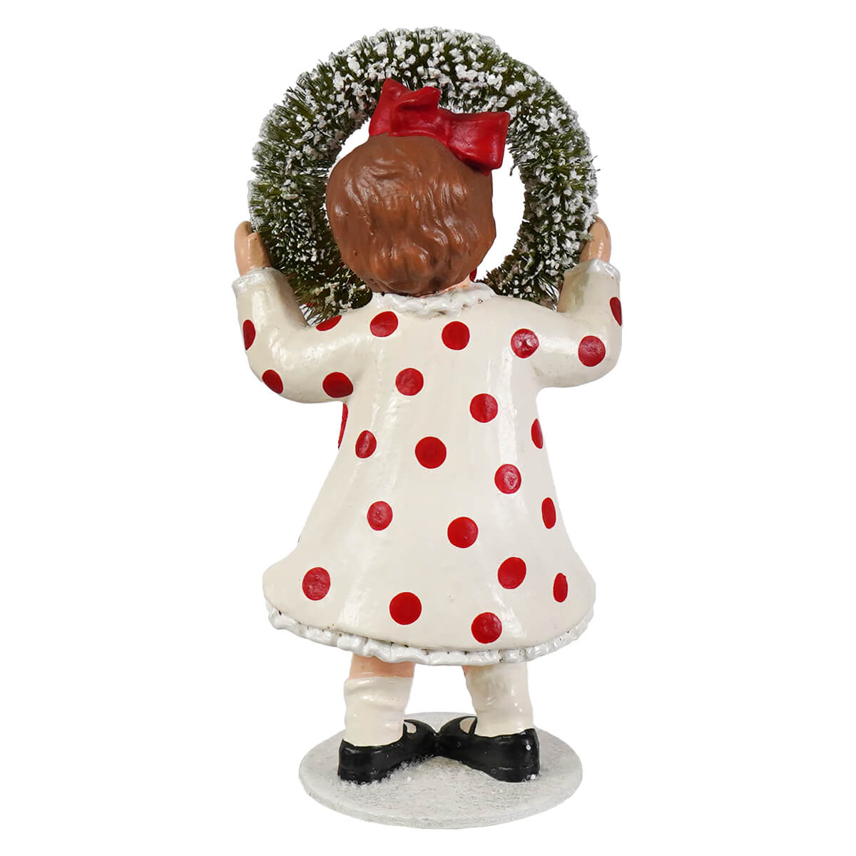 A bethany lowe design porcelain figurine noelle with wreath of a child in a white dress holding a snowy green wreath with a red bow