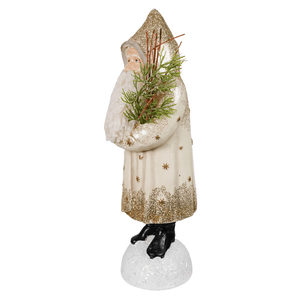 A festive nostalgic winter belsnickle santa figurine in white robe with gold stars spreading holiday cheer with pine branches