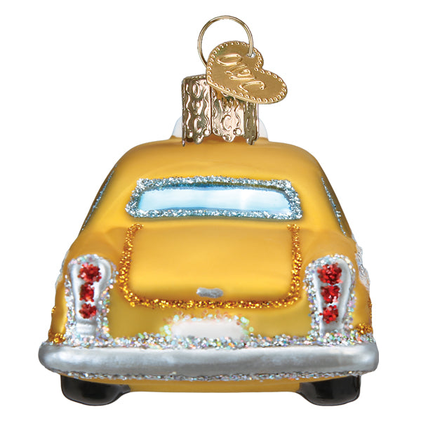 Golden glass nyc taxi ornament shaped like vintage car with red rhinestones and glittery silver trim for world christmas