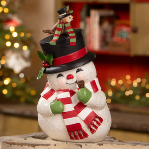 A charming white bethany lowe designs christmas snowman figure with red scarf green mittens and black top hat holding a pipe