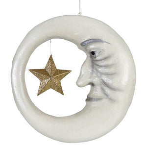 White crescent moon ornament with painted face and hanging gold glitter star in old man in the moon design