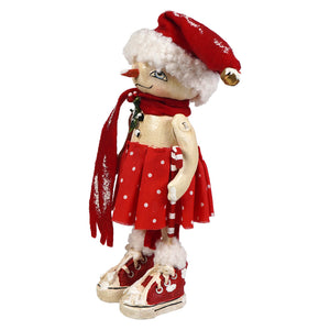 A whimsical olympia flake snowman figurine by bethany lowe designs with red glittery hat polka dot skirt and red sneakers
