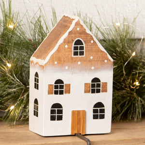 A charming wooden ombre house stocking holder with white base black windows and natural wood roof for christmas stockings