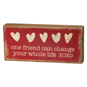 Red wooden friend block sign with distressed white hearts and cream lettering one friend can change your whole life box sign